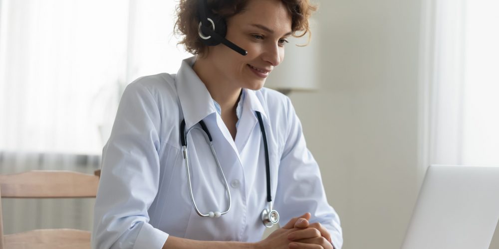 Pleasant,Happy,Young,Female,Doctor,Physician,Wearing,Headset,With,Microphone,